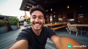 A candid photo of a social media influencer taking a selfie at an outdoor restaurant.