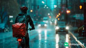 A DoorDash delivery worker riding his bike on a rainy Seattle day.